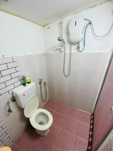 a small bathroom with a toilet and a shower at Simple2 Guesthouse in Pantai Cenang +15 photos