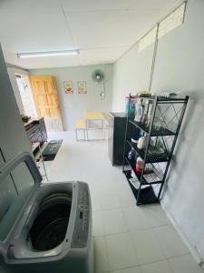 a room with a washing machine in a room at Simple2 Guesthouse in Pantai Cenang