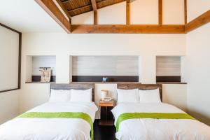Postel nebo postele na pokoji v ubytování Hotel Rakurakuan