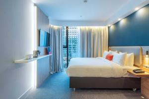 a hotel room with a large bed and a desk at Holiday Inn Express - Astana - Turan by IHG in Astana +144 photos