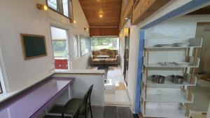 a tiny house with a purple counter and shelves at Tasha's Garden in Jeju