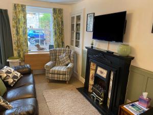 a living room with a fireplace and a television at 21 Entry Lane in Kendal