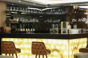 a bar with two chairs and glasses on shelves at Martinenz Hotel Old City in Istanbul +77 photos