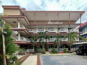 a large building with a parking lot in front of it at Tan Residence in Ko Lanta
