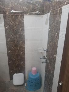 a small bathroom with a toilet and a shower at Arora classic guest house in Amritsar