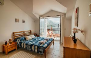 a bedroom with a bed and a large window at Holiday Home Amanda Hollick in Kotor