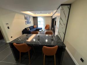 a kitchen and living room with a counter and chairs at Hilloria Residence in Serdivan