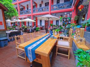 a wooden table and chairs on a patio at Wenjun Courtyard Hotel Chengdu ( Kuanzhai Branch) in Chengdu