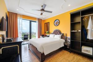 a bedroom with a white bed and a large window at Athenia Hoi An Boutique Hotel & Spa in Hoi An