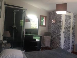 a bedroom with a bed and a door with a zebra print wall at Chez Calou in Mane