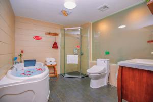 a bathroom with a tub and a toilet and a shower at Wenjun Courtyard Hotel ---5 mins walk from Tonghuimen metro station, near Tianfu square, close by culture park and Sichuan opera house, English speaking service, local tours in Chengdu