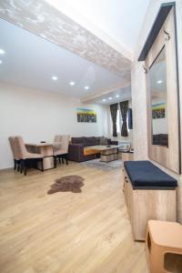 a living room with a couch and a table at GONDOLA apartman in Zlatibor