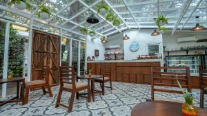 a restaurant with a glass ceiling and tables and chairs at Swimup - Suites with private pool , Vagator in Vagator