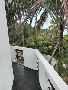 a view from the balcony of a house with palm trees at Absolute Breeze by cherins in Matara