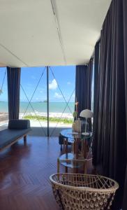 a living room with a view of the ocean at DEEPSPACE cabin on Quiet Beach in Ko Lanta