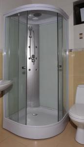 a glass shower in a bathroom with a toilet at Vila Caviar in Sulina +27 photos