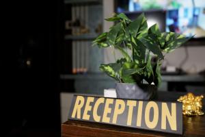 roślina na stole z znakiem, który czyta oddech w obiekcie Signature Inn Orchha w mieście Orchha