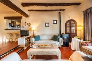 a living room with a couch and a table at Senrramada in Playa Migjorn