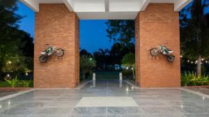 two motorcycles are hanging on the sides of a brick wall at Roadies Rostel - Best Adventure Resort in Ahmedabad in Kanīj