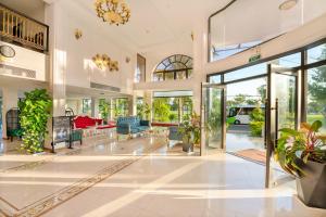 an open lobby with glass doors and plants at Athenia Boutique Hotel & Spa in Hoi An