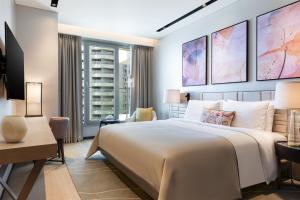 a bedroom with a large bed and a desk at JW Marriott Hotel Istanbul Marmara Sea in Istanbul
