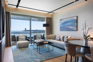 a living room with a couch and a table at JW Marriott Hotel Istanbul Marmara Sea in Istanbul