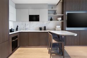 a kitchen with a table and a flat screen tv at JW Marriott Hotel Istanbul Marmara Sea in Istanbul