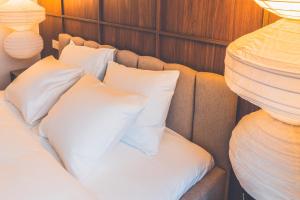 a bed in a room with white pillows at Second Home Stay 17 in Pärnu