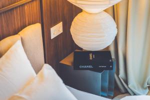 a lamp on top of a box next to a bed at Second Home Stay 17 in Pärnu +55 photos