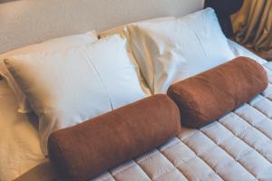 a brown rolled up towel on a bed with pillows at Second Home Stay 17 in Pärnu