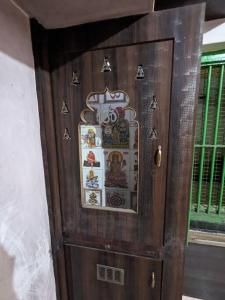 a wooden door with stickers on it next to a window at Padmini Nivas in Brahmapur