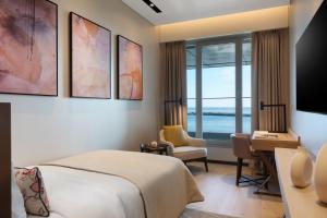 a hotel room with a bed and a desk and a window at JW Marriott Hotel Istanbul Marmara Sea in Istanbul