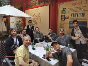 a group of men sitting around a table at Wenjun Courtyard Hotel ---5 mins walk from Tonghuimen metro station, near Tianfu square, close by culture park and Sichuan opera house, English speaking service, local tours in Chengdu