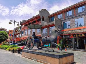 a statue of a horse pulling a carriage on a street at Wenjun Courtyard Hotel ---5 mins walk from Tonghuimen metro station, near Tianfu square, close by culture park and Sichuan opera house, English speaking service, local tours in Chengdu