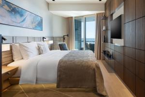a hotel room with a bed and a tv at JW Marriott Hotel Istanbul Marmara Sea in Istanbul