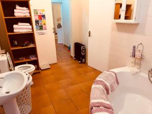 a bathroom with a tub and a toilet and a sink at Haze Inn Cottage in Rosetta +9 photos