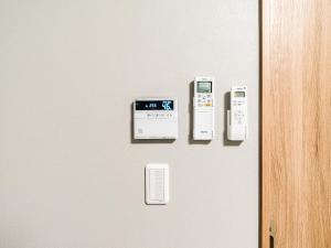 a door with a bunch of electronic devices on it at Rakuten STAY MOTEL Kujukurihama Katakai in Kujukuri