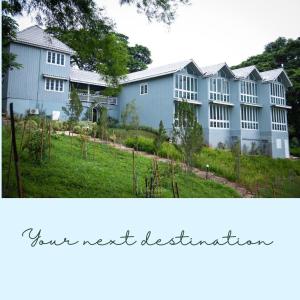 a large blue building with the words home excellence at Hacienda Home in Tha Sut
