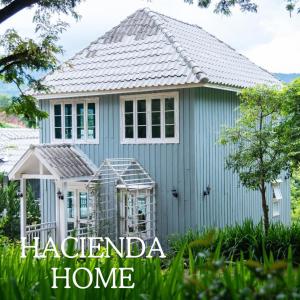 a small blue house with the words hacienda home at Hacienda Home in Tha Sut