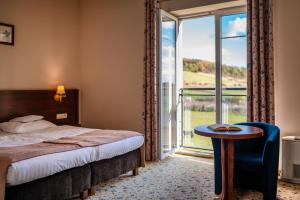 a hotel room with a bed and a large window at Dosłońce Resort Wellness & Farm in Racławice +172 photos
