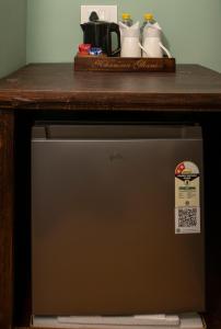 a small refrigerator under a counter with a wooden top at Khamma Ghani A Boutique Hotel in Udaipur