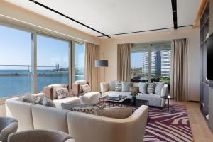 a living room with white furniture and large windows at JW Marriott Hotel Istanbul Marmara Sea in Istanbul