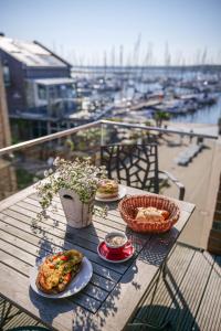 a table with plates of food on a balcony at Ostsee - Appartement "Pier 76" im Strand Resort in Heiligenhafen
