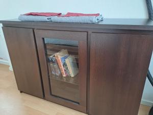 a wooden table with a shelf with books at Hero Avenue Apartment in Narva