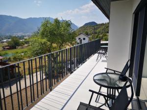 a balcony with chairs and a view of the mountains at Apartments Ole in Tolmin