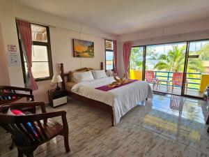 a bedroom with a large bed and a balcony at Lanta MP Place in Ko Lanta +78 photos
