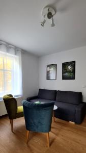 a living room with a couch and two chairs at Apartamenty Dębowa 3 in Polanica-Zdrój