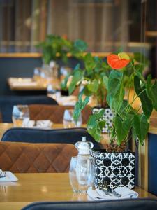 a flower in a vase on a table in a restaurant at Future Inn Cardiff Bay in Cardiff