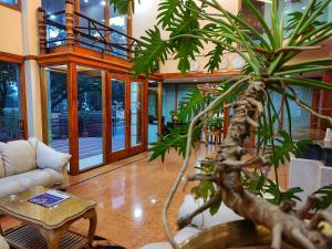 a living room with a couch and a table at Hotel Presidency Kempegowda International Airport Bangalore in Devanhalli