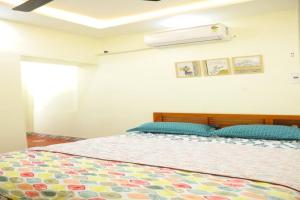 sypialnia z łóżkiem z kolorową kołdrą w obiekcie Heritage home with 2 bed/2 bath with kitchen in a residential neighborhood. w mieście Maduraj